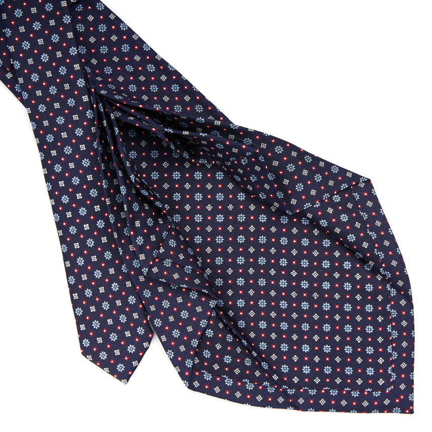 dark_blue_9_fold_sartorial_silk_tie_small_flower_pattern_detail_of_the_back_pleats