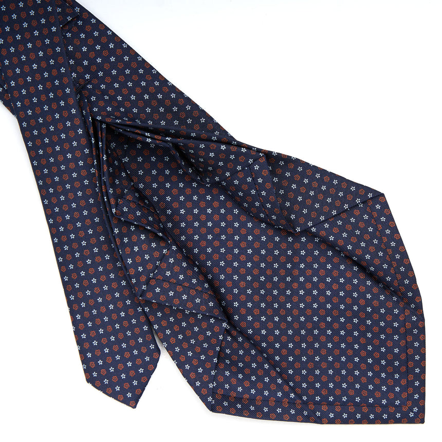 dark_blue_9_fold_sartorial_silk_tie_small_flower_pattern_detail_of_the_back_pleats