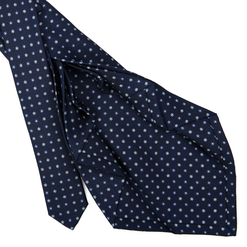 dark_blue_9_fold_sartorial_silk_tie_small_flower_pattern_detail_of_the_back_pleats