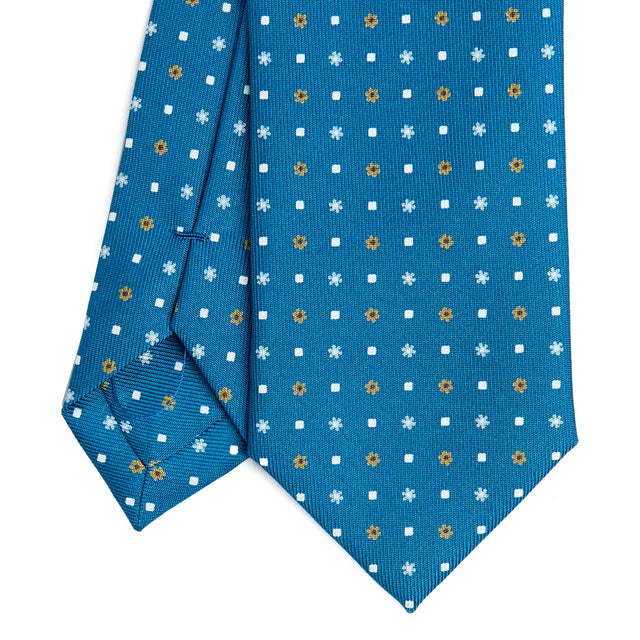 mid_blue_sartorial_7_cm_silk_tie_small_flower_pattern_tip_detail