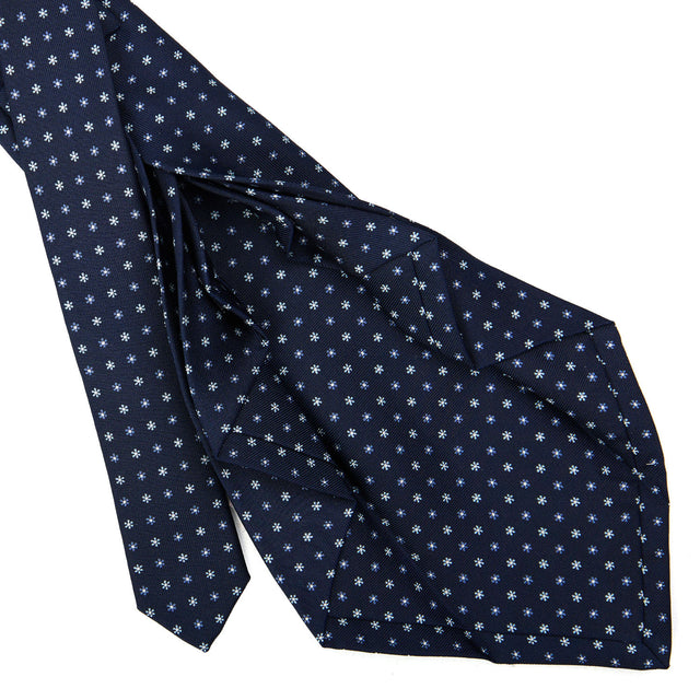 dark_blue_9_fold_sartorial_silk_tie_small_flower_pattern_detail_of_the_back_pleats
