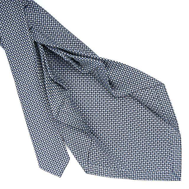 dark_blue_9_fold_sartorial_silk_tie_small_flower_pattern_detail_of_the_back_pleats