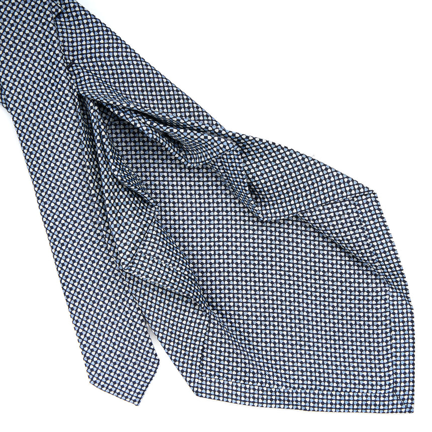 dark_blue_9_fold_sartorial_silk_tie_small_flower_pattern_detail_of_the_back_pleats